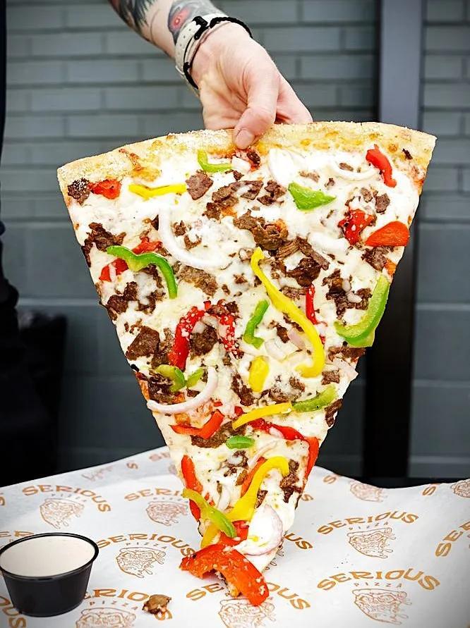 Why So Serious? Giant Pizza-By-The-Slice in Deep Ellum