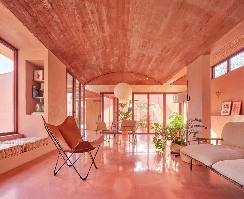 A Home in the Surrounding hills of Barcelona Matches the Red Hues of the Earth