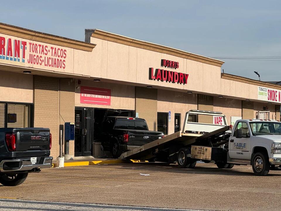 Pickup truck crashes into laundromat after driver's foot slips and hits