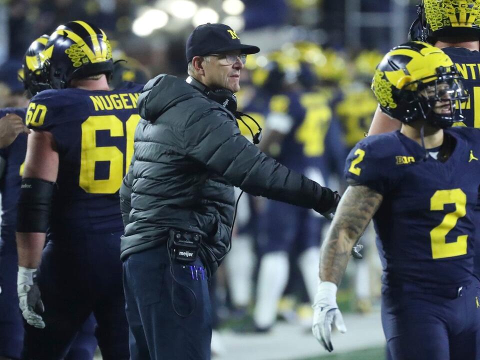 Michigan football coach defends players amid cheating allegations