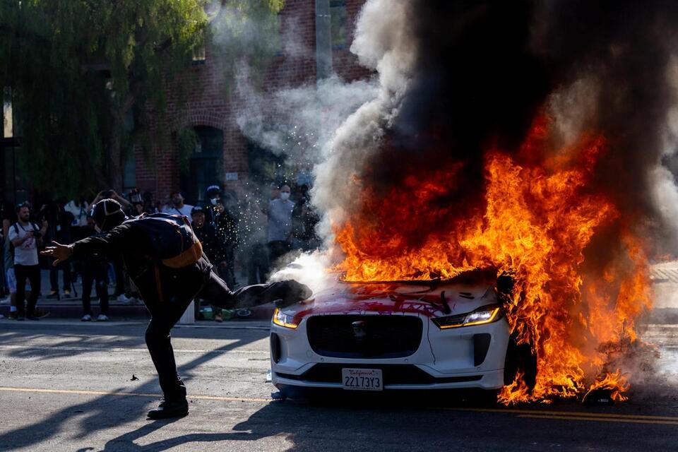 Waymo suspends downtown L.A. service after protesters set fire to self ...
