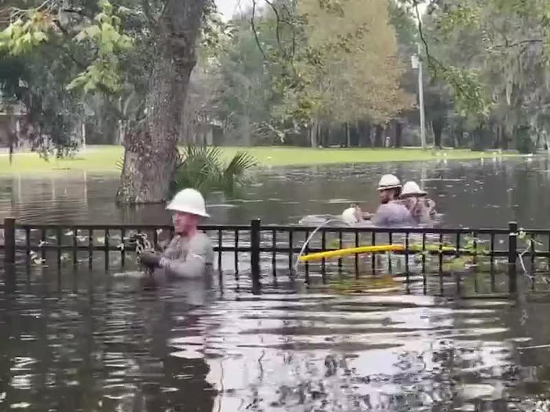 Crews work in floodwaters to restore power to customers