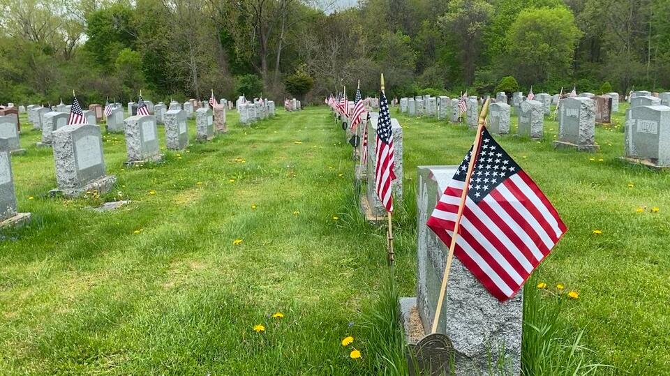 Veterans and volunteers place flags at veterans' graves ahead of ...