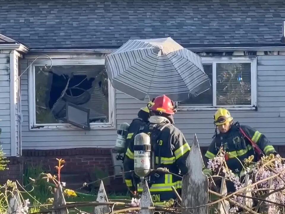 Bystander throws chair through window of burning home