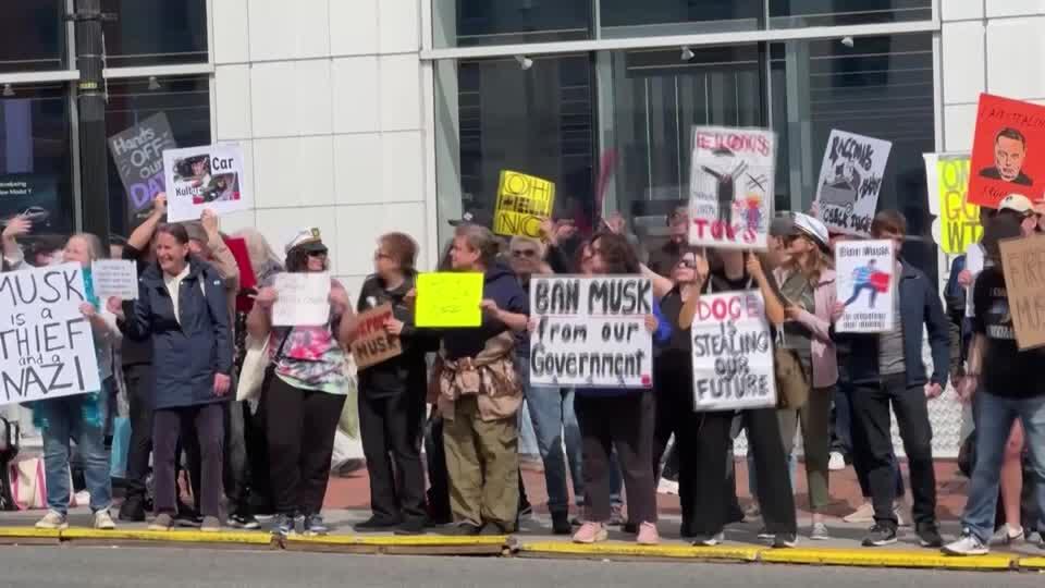 Anti-Musk protesters dance outside Washington DC Tesla showroom - NewsBreak