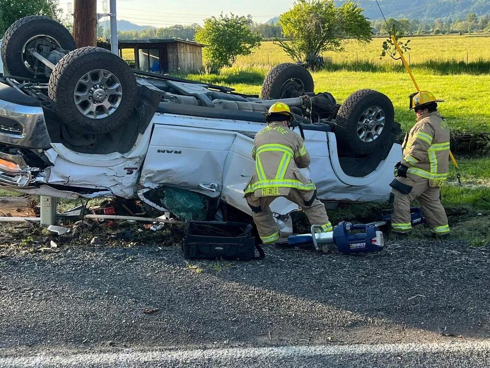 Firefighters rescue men trapped in pickup truck following power pole ...