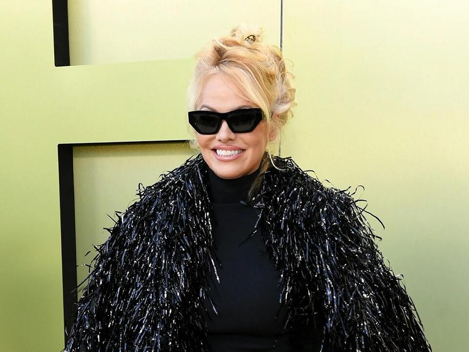 Pamela Anderson Wears Scene-Stealing Fringe Coat & Pointy Pumps at