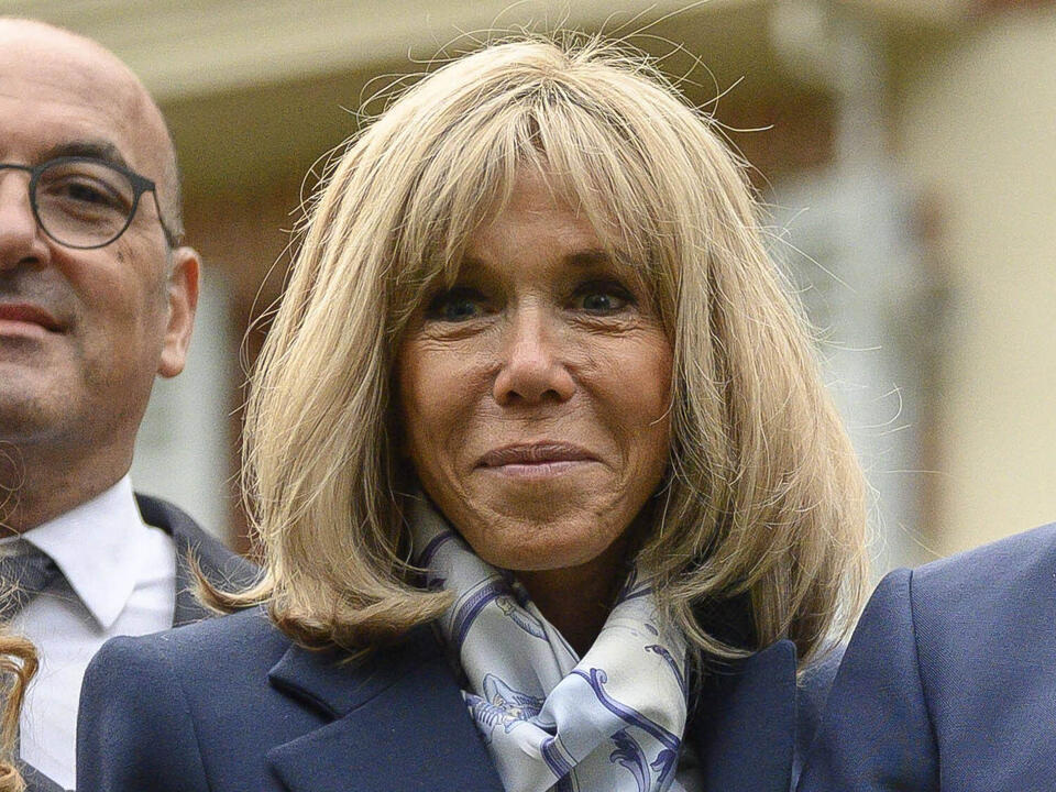 French First Lady Brigitte Macron Elevates Classic Navy Suiting With Graphic Louis Vuitton Ankle Boots – NewsBreak