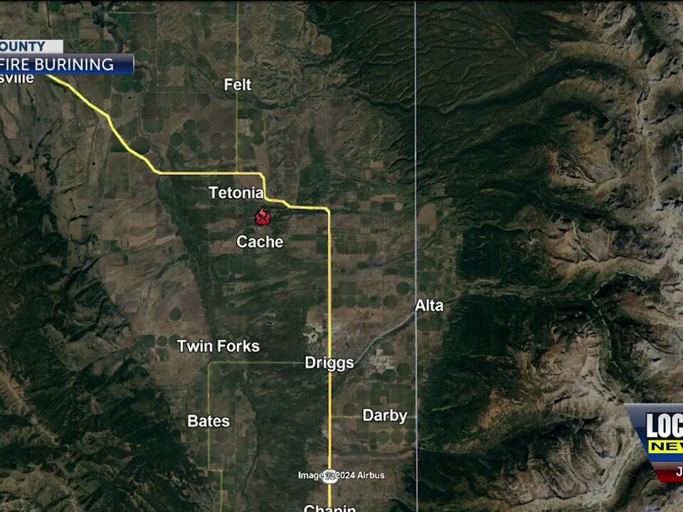 Fire crews defend structures from a brush fire near Tetonia