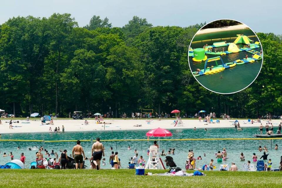 This secluded 178-acre lake escape is hidden inside a mountain forest just 1 hour from NYC—with white sand beaches & a massive floating obstacle course