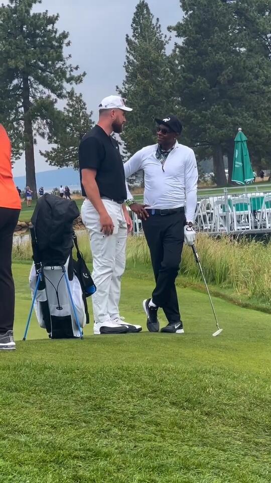 Travis Kelce and Jerry Rice chat on the golf course at the 35th annual ...