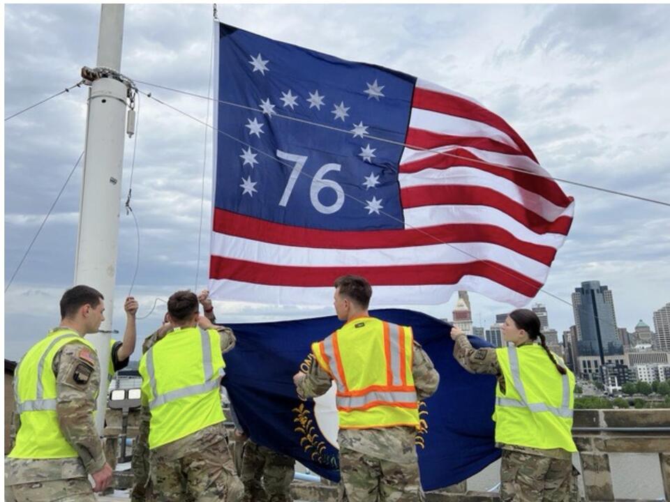 University of Cincinnati ROTC members replace flags atop Roebling Bridge