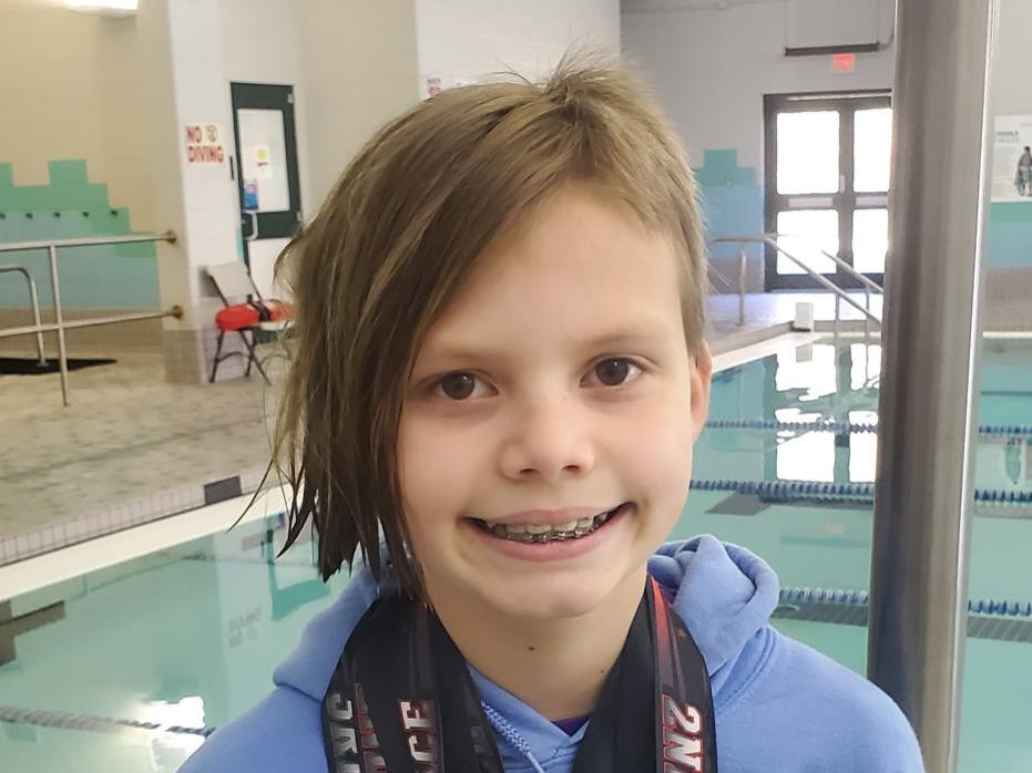 YMCA Dolphins swim team member competes in Regional Meet