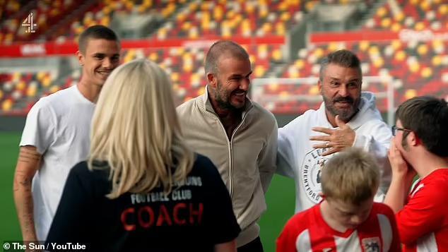 David Beckham embraces Unsung Heroes award winner Allan Cockram during ...