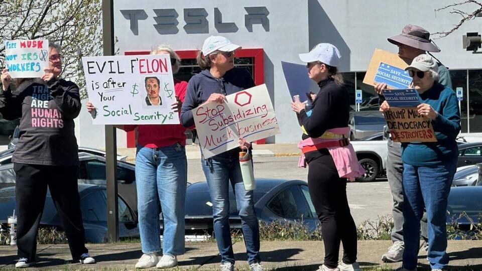 Protesters rally against Elon Musk outside Franklin Tesla dealership ...