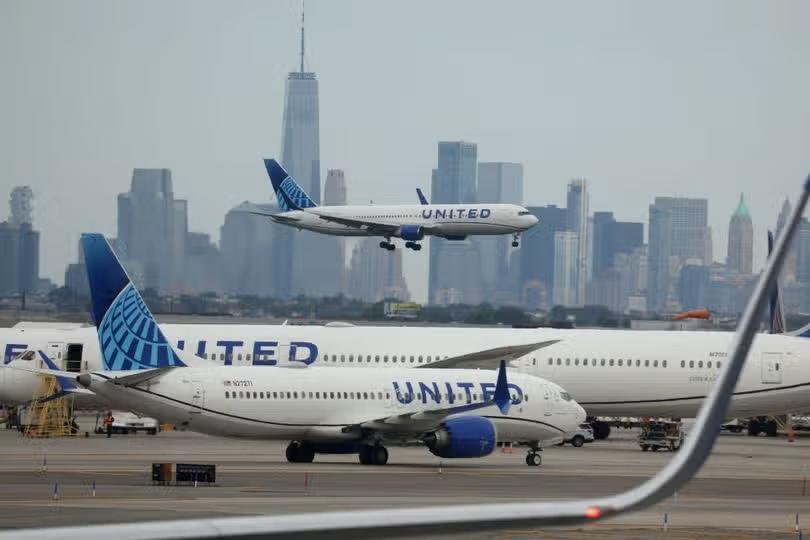 Drunk Russian passenger on way to NJ 'bit flight attendant and tried to open a door midair'