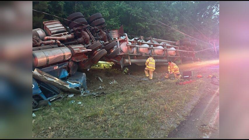 Driver freed after three hours of being stuck under overturned 18 ...