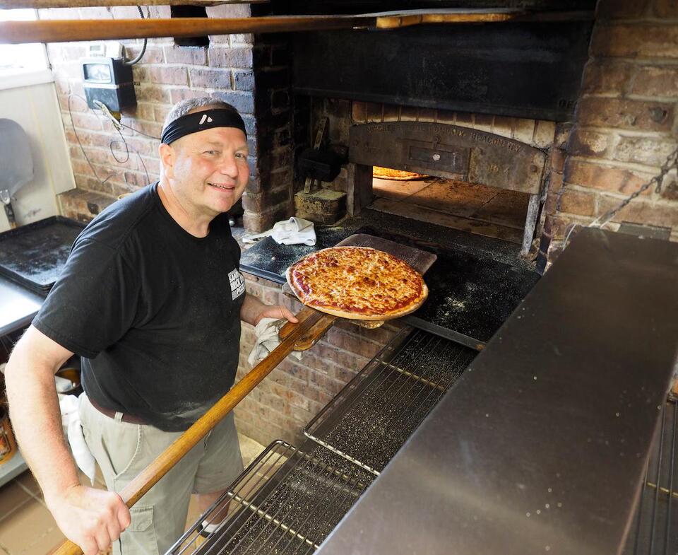 Iconic pizzeria, rebuilding from fire, may soon be for sale. Here's why.